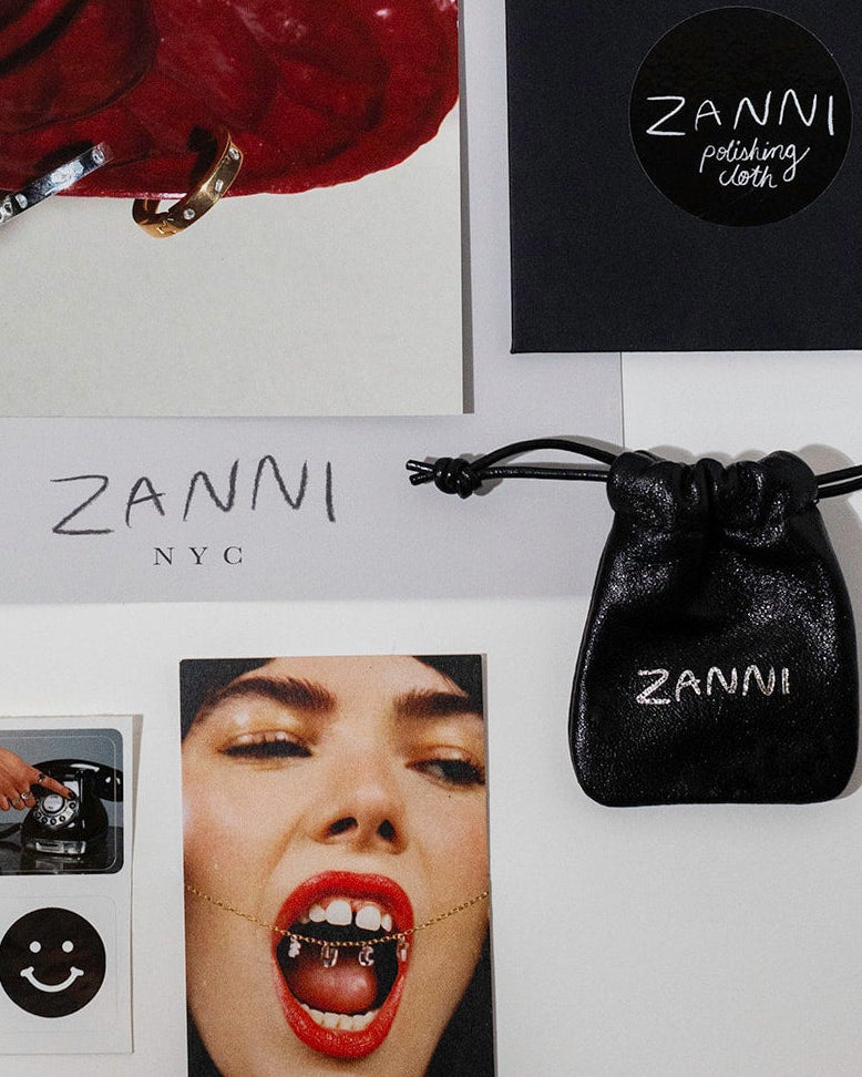 Zanni jewelry pouch and polishing cloth with brand name on a white background