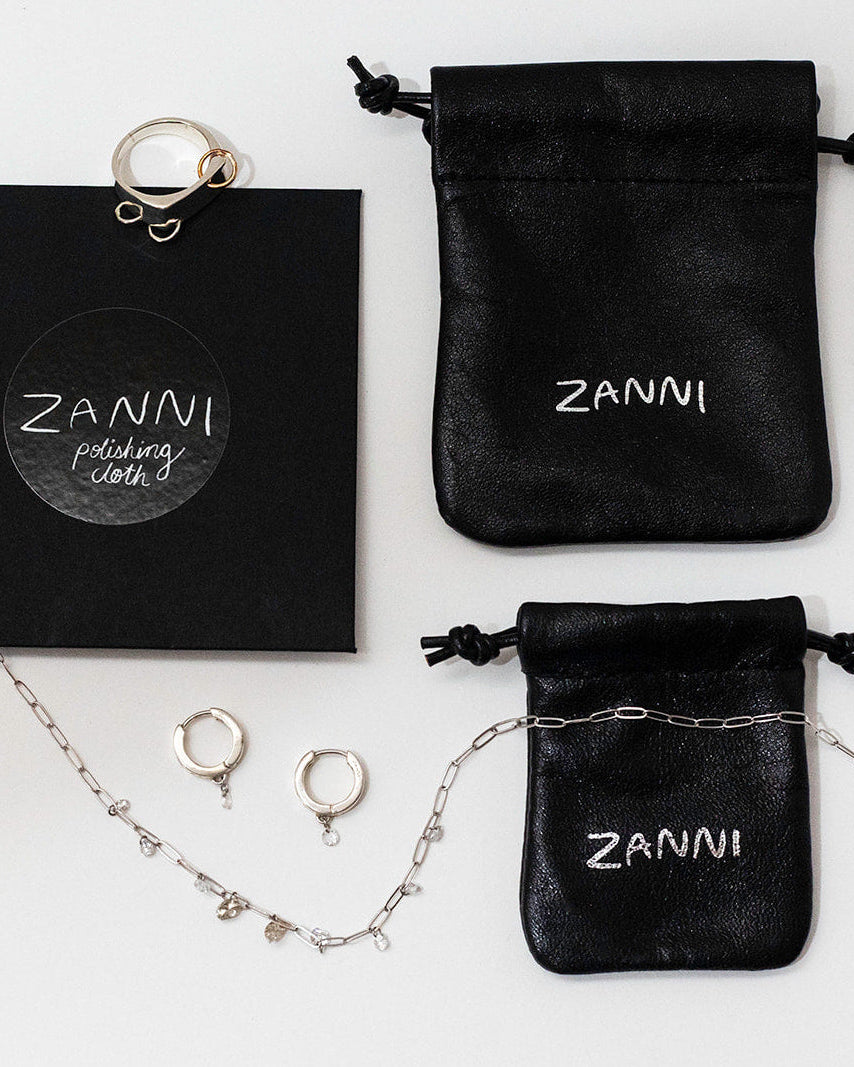 Jewelry set with Zanni packaging and jewelry bags on a white background