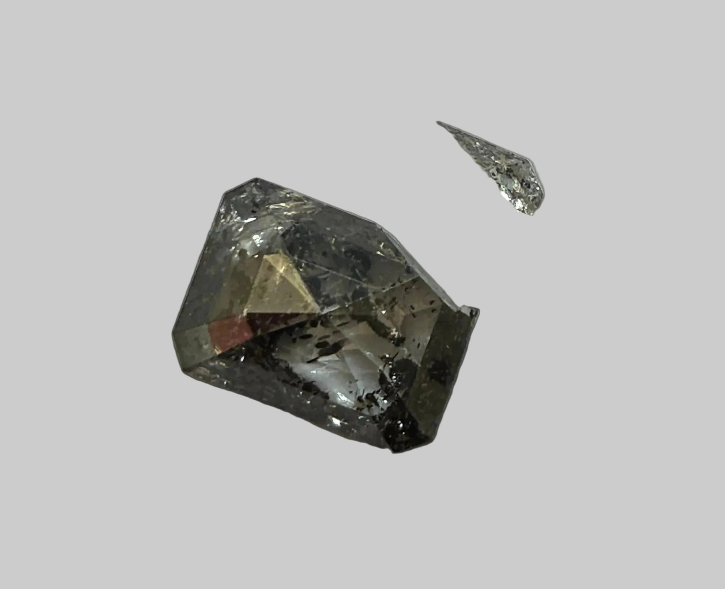 broken salt and pepper emerald cut diamond