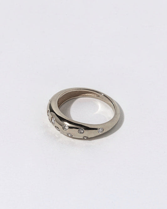 Silver ring with small white diamonds on a white background