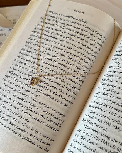 Open book with a necklace draped over it