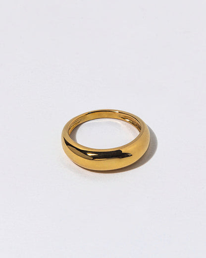 Gold ring on a light gray background