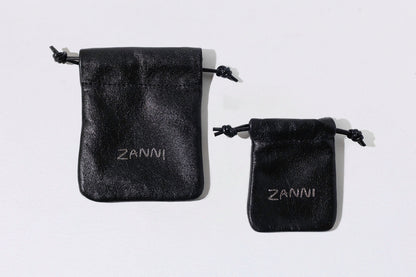 Two black velvet pouches with 'Zanni' branding on a white background