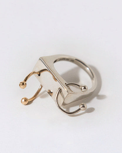 Gold ring with a unique design on a white background