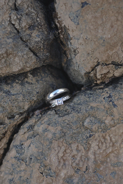 two silver diamonds rings in rocks
