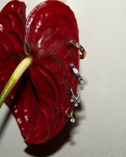 Flower with four hoops and huggies in gold and silver with diamonds pierced into them 