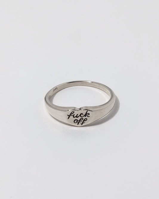 Silver ring with 'f**k off' engraving on a white background