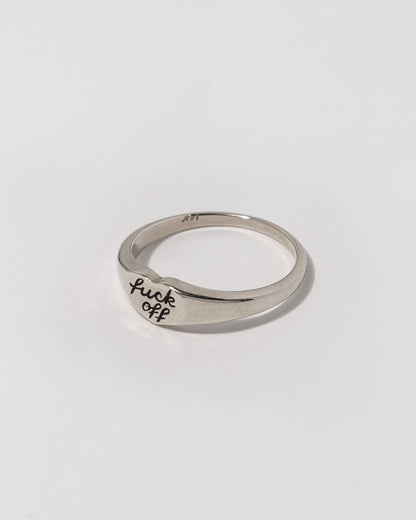 Silver ring with 'f*ck off' engraving on a white background